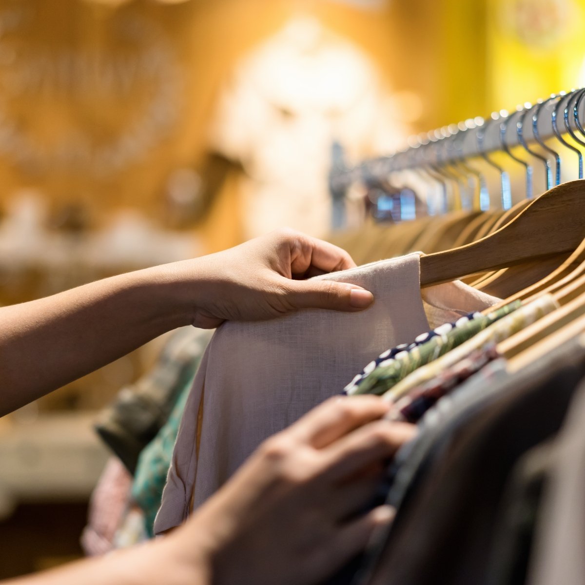 A shopper browsing clothing on a rack